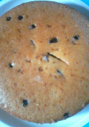 A picture of Eggless vanilla cake with orange zest and chocochips ( in pressure cooker).