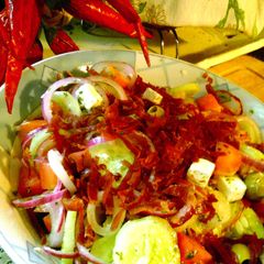 A picture of feta and prosciutto salad with mint topping.