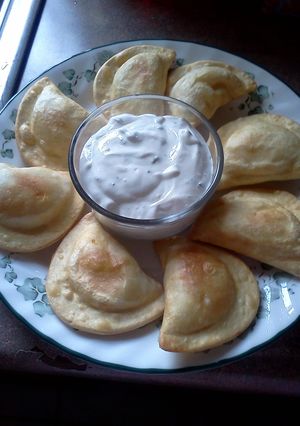 A picture of Fried Pierogies w/ Sour Cream n Chives.