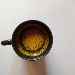 A picture of Turmeric And Desi ghee with Water.