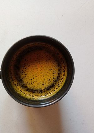 A picture of Turmeric And Desi ghee with Water.
