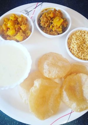 A picture of Milk custard and potato sabji and namkin.