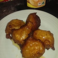 A picture of Ricotta and orange fritters with honey.