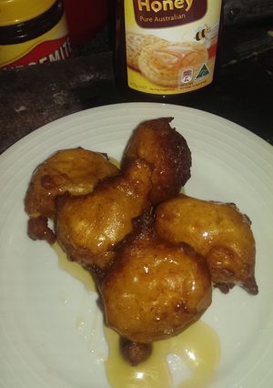 A picture of Ricotta and orange fritters with honey.