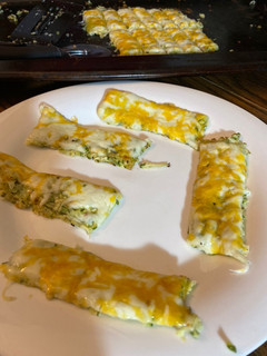 A picture of Cheesy zucchini sticks.