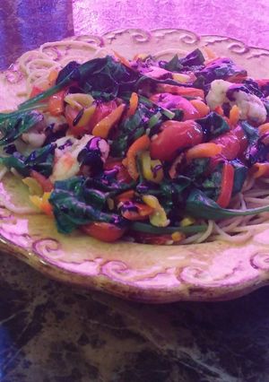 A picture of Shrimp mixed garden pasta with balsamic glaze.