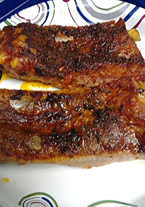 A picture of Ribs in an oven.