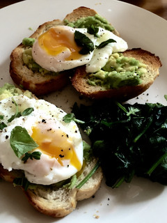 A picture of Poached Eggs with Avocado and Spinach.