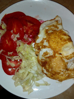 A picture of Fried egg with salad#localfoodcontest-mombasa.