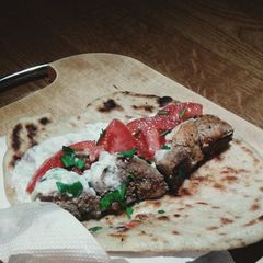 A picture of Greek souvlaki pork kebab and tzatziki sauce.
