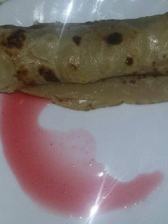A picture of Pancake with jam sauce.