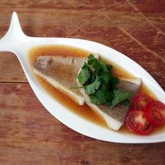 A picture of Poached Halibut Fillet In Chicken In Superior Chicken Soup.