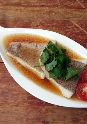 A picture of Poached Halibut Fillet In Chicken In Superior Chicken Soup.