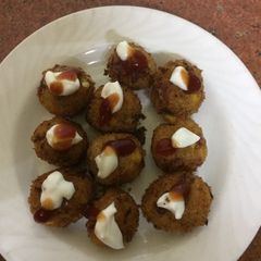 A picture of Arancini with cheesy corn and mayo.