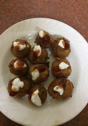 A picture of Arancini with cheesy corn and mayo.