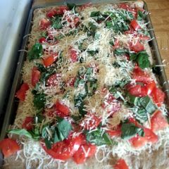 A picture of olive oil tomato basil pizza.