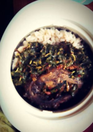 A picture of Rice & Beans with roasted fish & steamed Spinach.