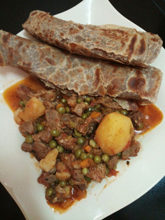 A picture of Beef peas stew with brown chapati.