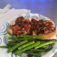 A picture of baked salmon w tomato cilantro relish.