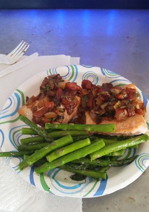 A picture of baked salmon w tomato cilantro relish.