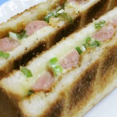 A picture of Weiner Sausage Toasted Sandwich with Green Onions.