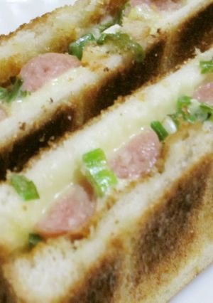 A picture of Weiner Sausage Toasted Sandwich with Green Onions.