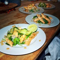 A picture of Lemongrass chicken with mihoe and spinach & cucumber salad.