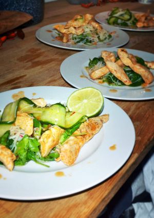 A picture of Lemongrass chicken with mihoe and spinach & cucumber salad.
