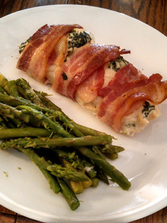 A picture of creamy spinach, bacon wrapped chicken breasts.