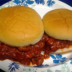 A picture of three meat sloppy joes.
