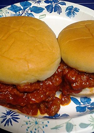 A picture of three meat sloppy joes.