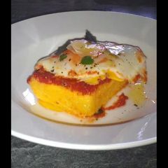 A picture of Polenta with Tomatoe Basil Sauce and Poached Egg.