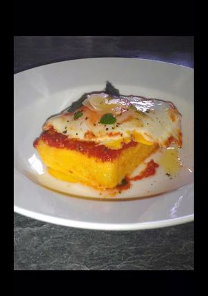 A picture of Polenta with Tomatoe Basil Sauce and Poached Egg.