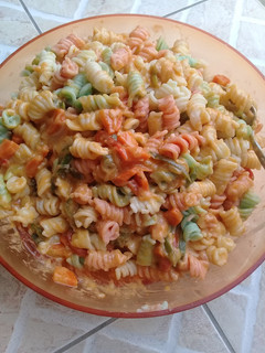A picture of 3 colours fossil with bacon pasta sauce.