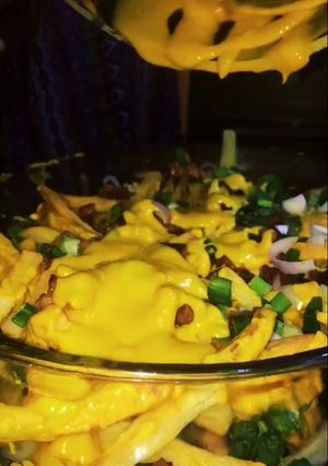 Una foto de Papas con cheddar
