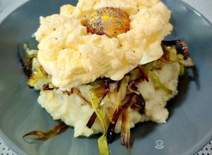 Una foto de Parmentier trufado de patata y parmesano con crujiente de puerro y huevo nube