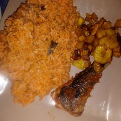 A picture of Jollof rice wit fried fish and plantain.