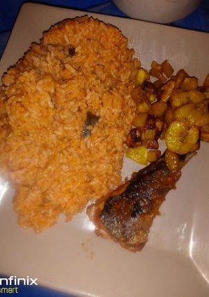 A picture of Jollof rice wit fried fish and plantain.