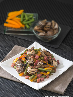 Una foto de Wok de caracoles con verdura y jamón
