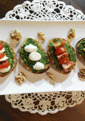 A picture of Bruschetta with Arugula Pesto.