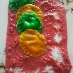 A picture of Sweet ravioli with beet sauce.