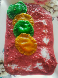 A picture of Sweet ravioli with beet sauce.