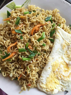 A picture of Noodles and fried egg.