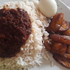 A picture of Rice,egg and fried plantain.