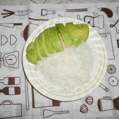 A picture of Plain rice served with avocado.