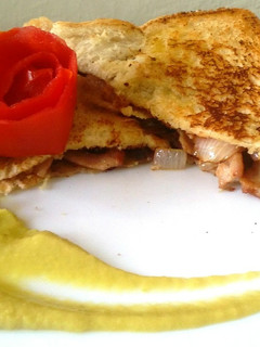 A picture of Bacon and onion sandwich.