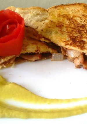 A picture of Bacon and onion sandwich.