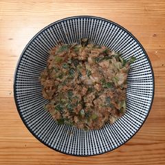 A picture of Spring onion with spicy peanut dressing.