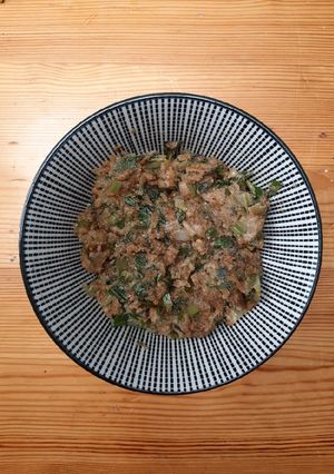 A picture of Spring onion with spicy peanut dressing.