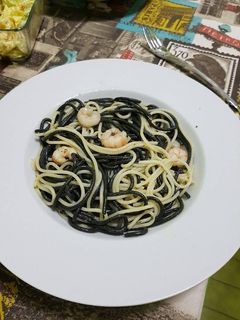 Una foto de Espaguetis negros y blancos con gambas